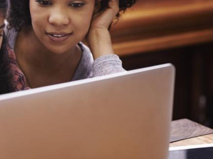 Mother and daughter viewing laptop