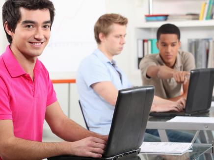 Students on laptops in library.