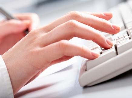 Typing on computer.